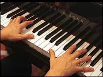 Hands Playing A Piano